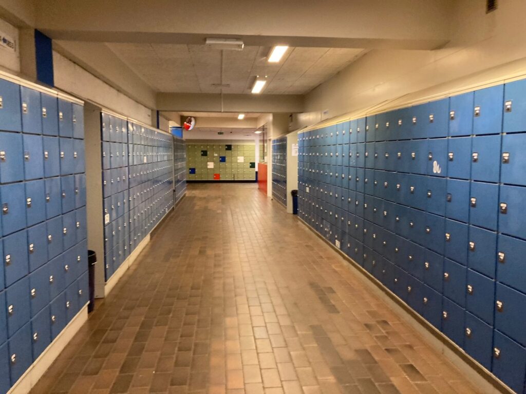 School hallway lined with blue lockers